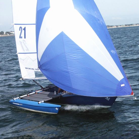 The new in 2004 Blue Magnum 21 with blue/white star cut spinnaker.