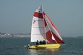 Yellow MAGNUM 21
with a red spinnaker.
